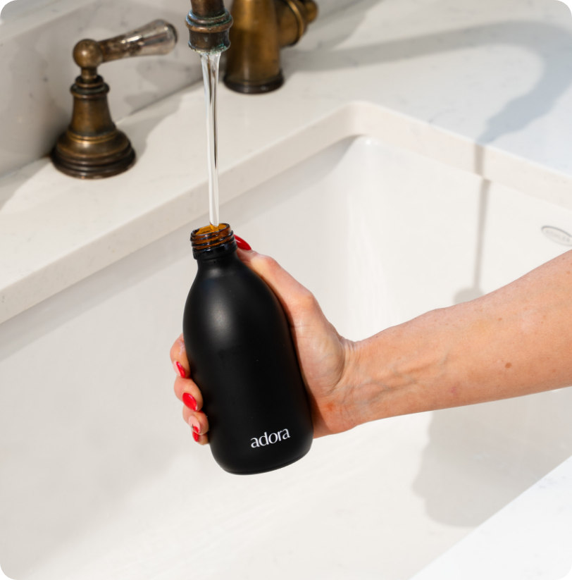 Close up of Adora glass spray bottle refillable cleaning product sustainable packaging